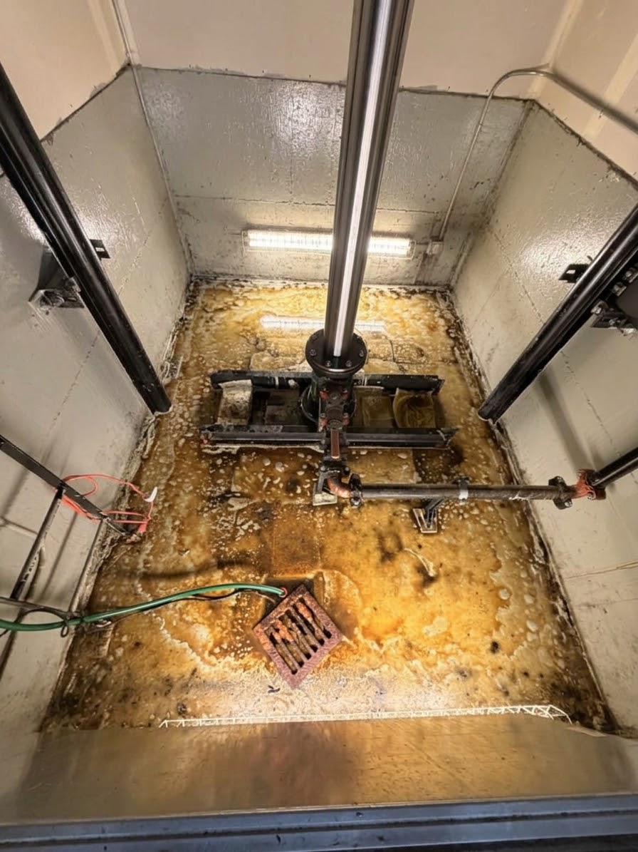 Before documented treatment: standing water in the elevator pit.